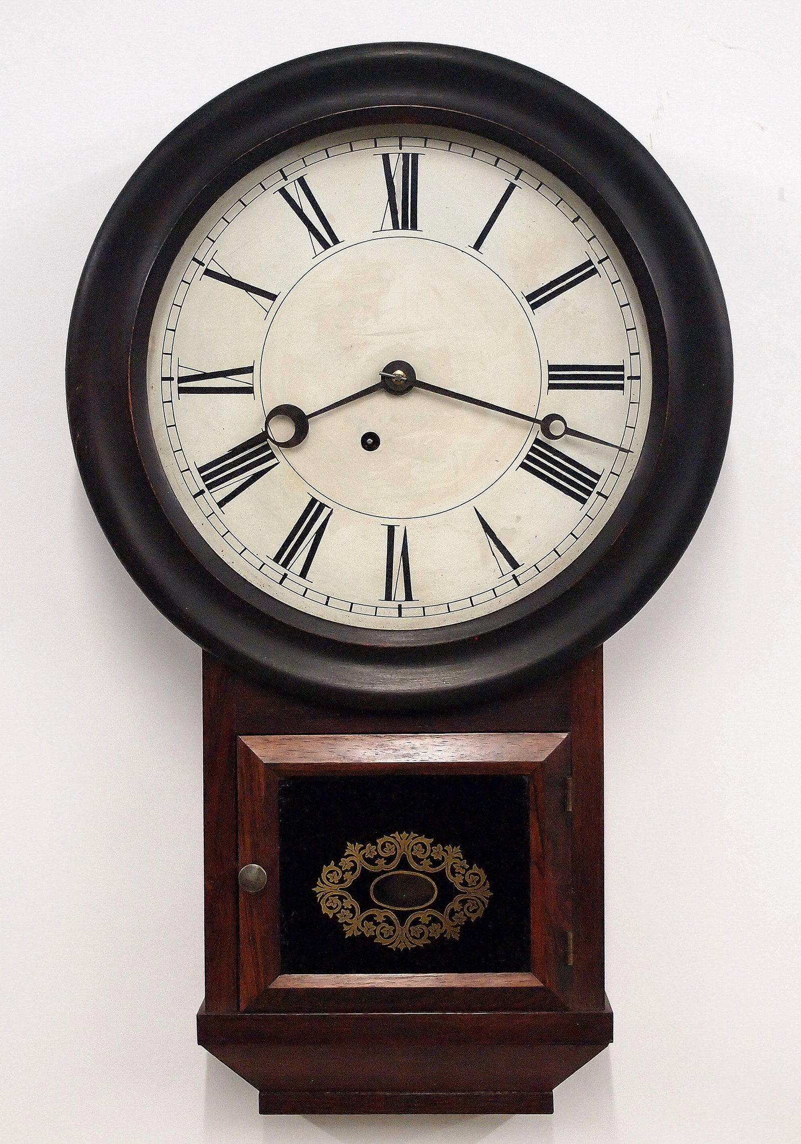 Atkins Round Head Drop Wall Clock: A mid 19th century Atkins Clock Co. Round Head Drop model wall clock. 8-day spring driven time only movement with painted metal dial and Roman numerals. Rosewood case with painted bezel, lower door wi