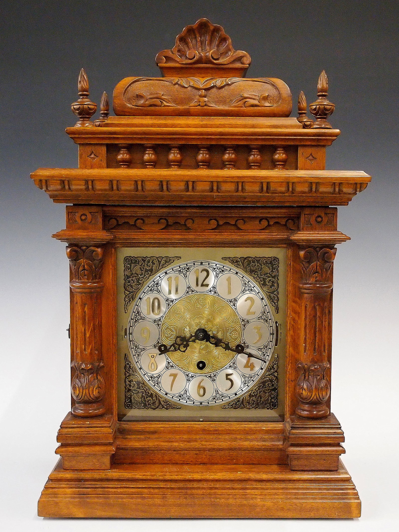 Urgos Bracket Clock: A late 20th century Urgos (Germany) Bracket clock. 8-day time and strike movement with lever escapement, quarter hour Westminster/Whittington/Winchester chimes, Brass dial with applied spandrels, engr