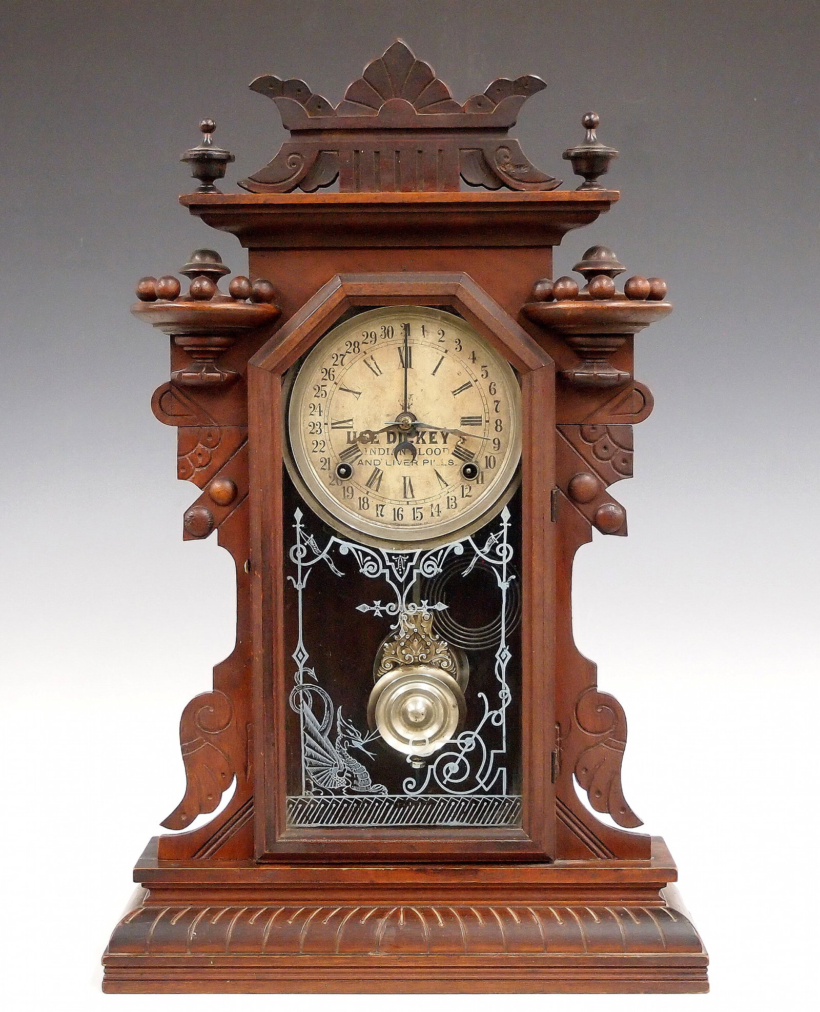 Waterbury Hudson Model Advertising Kitchen Clock: A turn of the century Waterbury Hudson model kitchen shelf clock with "Use Dickey's Indian Blood And Liver Pills" advertising dial. 8-day time and strike movement with simple calendar. Walnut case wit