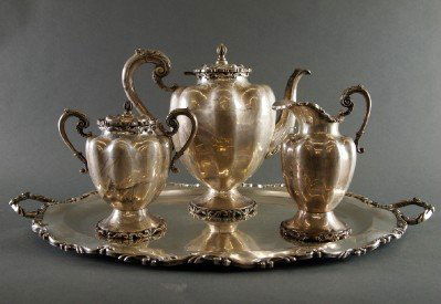 Sterling Silver tea set: A 20th century Taxco three piece Sterling Silver Tea set with tray. Rococo style Teapot, creamer, covered sugar and two handle tray with scrolled foliate edges. Incised marks "California, Taxco, Plate