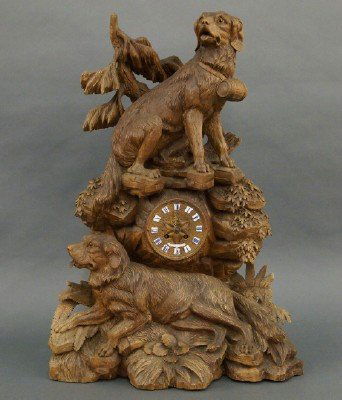 Black Forest shelf clock: A 19th century Black Forest Carved Walnut shelf clock with St. Bernard dogs on a rocky outcropping. 8-day Japy Freres French spring driven time and strike movement with original retailer's label of "E