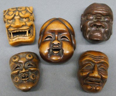 5 small Japanese masks: Five small Japanese carved wooden masks. Various images and woods, some appear to be for handkerchief or string ties. Two with signatures verso. Wear and some minor damage. Up to 2" high. ESTIMATE $10