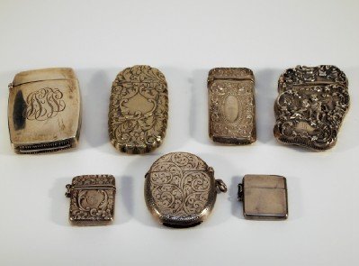 7 Silver Match and Stamp boxes: Seven turn of the century Match and stamp boxes, six are marked Sterling. Some with Repousse decoration. Minor wear. 3.30 troy ozs. Sterling. ESTIMATE $100-200