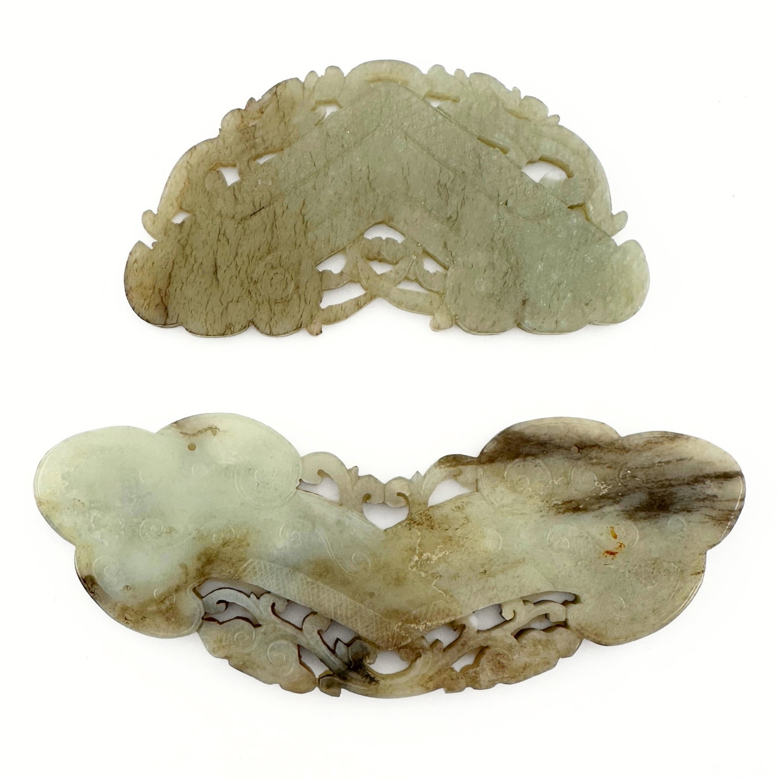 2 Chinese Carved Jade Plaques: Two Chinese carved Jade plaques. Reticulated and relief carved designs depicting arched chime stone forms with beasts and stylized clouds. Some surface wear and very minor damage, some inclusions and 