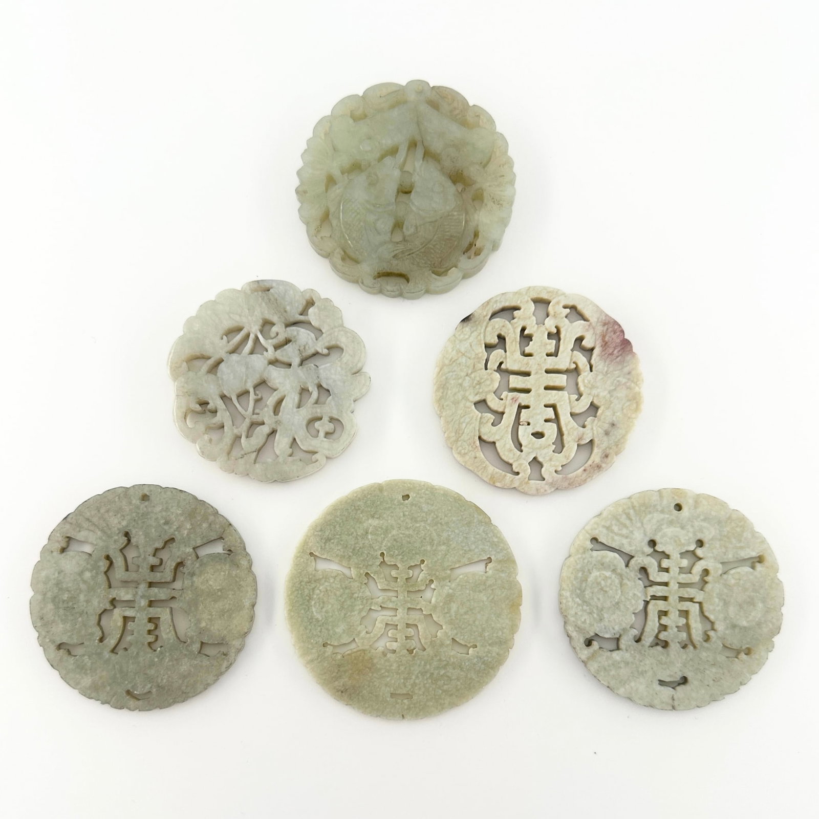6 Chinese Carved Jade Medallions: Six Chinese carved Jade medallions. Reticulated and relief carved designs with auspicious characters and carved decoration depicting florals and two entwined Koi fish known as the "Pair of Golden Fish