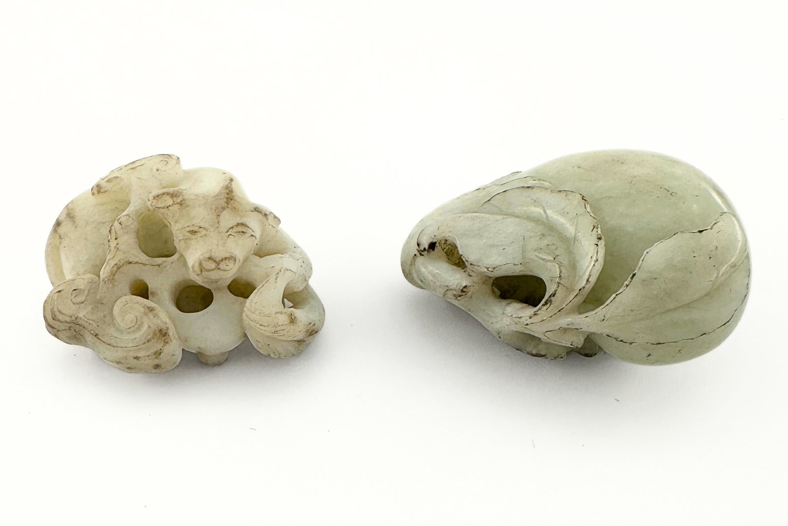 2 Chinese Carved Jade Figures: Two Chinese carved Jade figures. Includes auspicious carvings of a gourd and a small creature curled around clouds. Surface wear and minor inclusions, small spots of discoloration. Up to 1 7/8" high. 