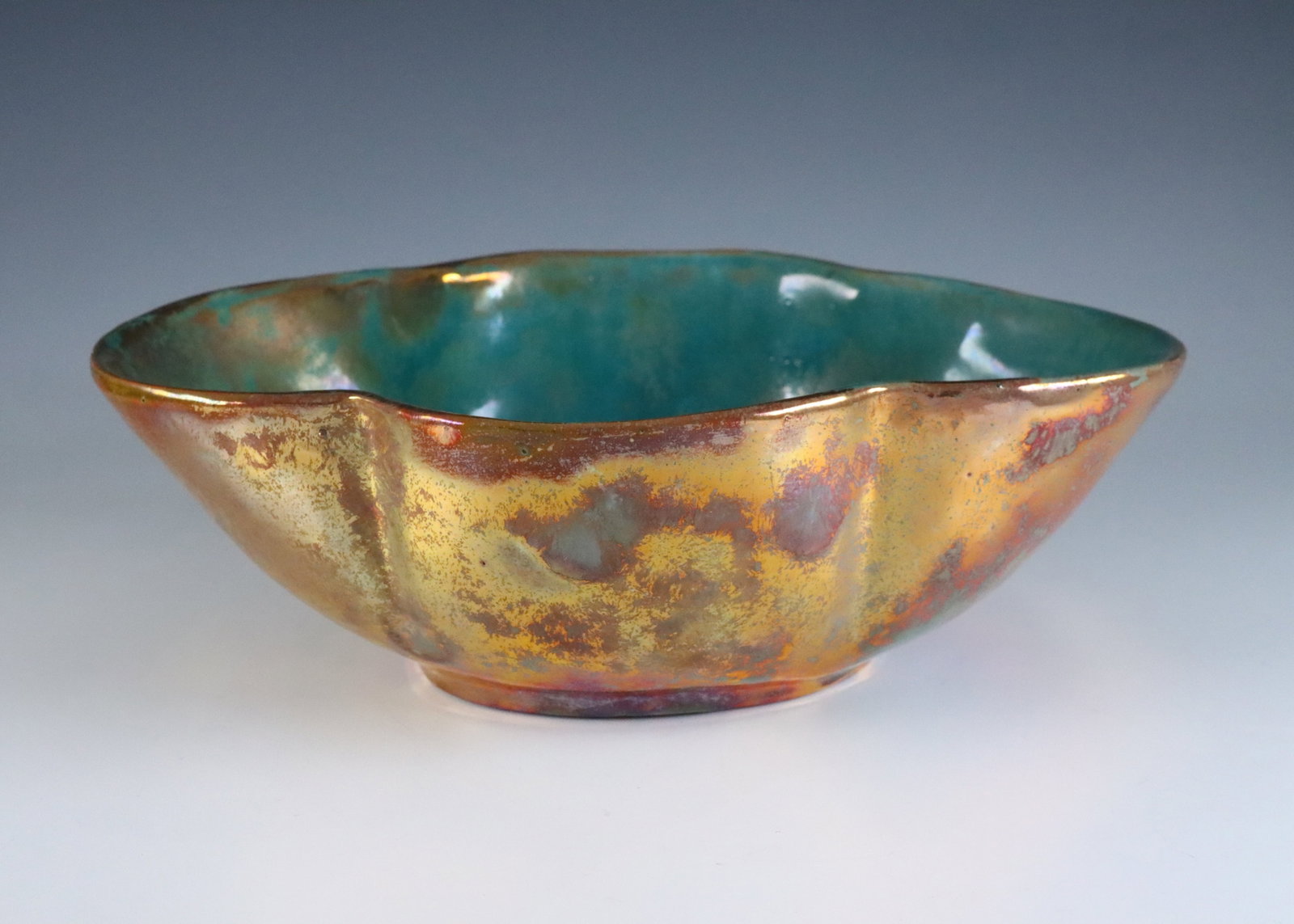 Pewabic Pottery Vase: An early 20th century Pewabic Pottery vase. Quatrefoil form with iridescent glaze in shades of Green, Oxblood and Gold. Impressed circular "Pewabic Detroit" mark. Crazing to interior. 8 x 2 3/4" high 