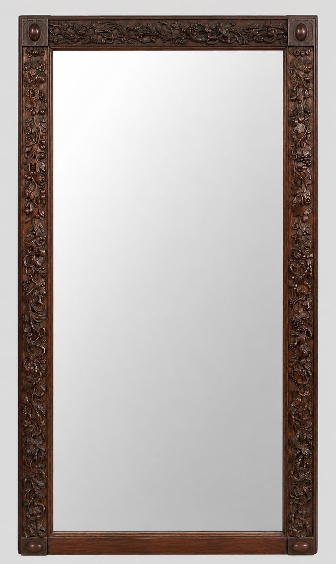 Victorian Carved Oak Mirror: A late 19th century American Victorian Period carved mirror. Oak construction featuring floral, pinecone, grape cluster, leaf, and vine motifs in high relief. Wear and some nicks to the wood, some los
