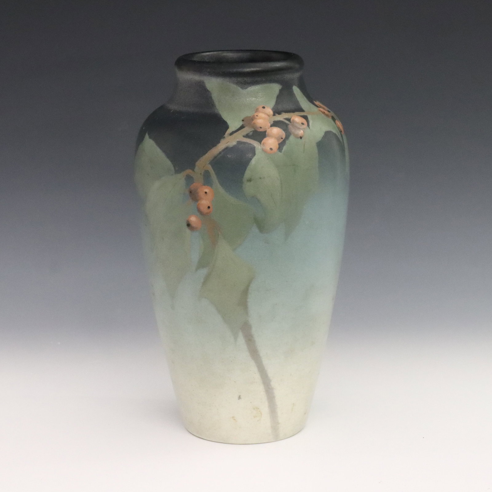 Rookwood Vellum Vase: An early 20th century Rookwood Vellum Art Pottery vase decorated by Sara Sax. Baluster form with polychrome leaf and berry decoration on a tonal Green ground. Impressed Rookwood mark, Roman numerals "