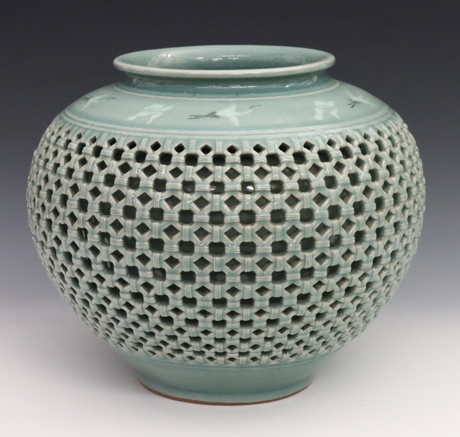 Korean Celadon Porcelain Vase: A Korean Goryeo-style reticulated Celadon porcelain vase. Rounded form double wall porcelain vase with reticulated basketweave design about the body and flying crane and cloud pattern above the should