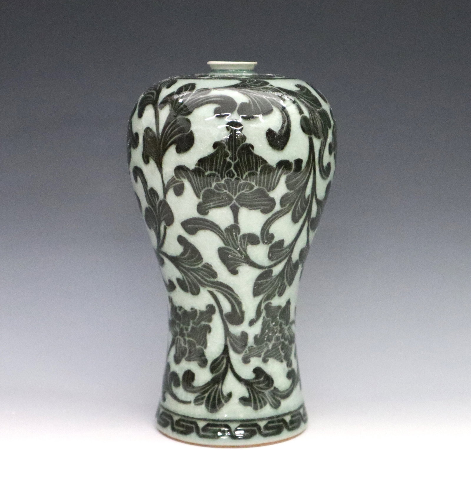 Korean Celadon Porcelain Vase: A Korean Goryeo-style Celadon porcelain plum vase. Inverted baluster form Maebyeong vase with high shoulder and tapered waist, decorated with a contrasting floral design in a crackle glaze. Marked at 