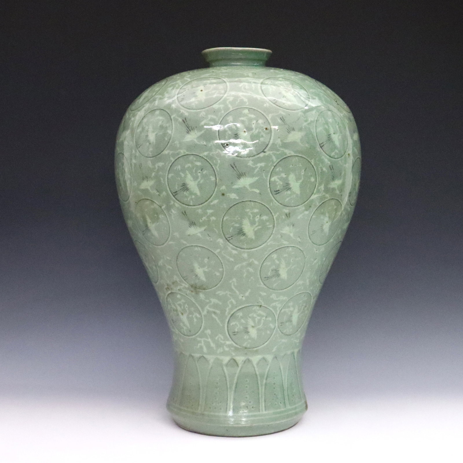 Korean Celadon Porcelain Vase: A Korean Goryeo-style Celadon porcelain plum vase. Inverted baluster form Maebyeong vase with high shoulder and tapered waist, decorated with cranes and medallions above a lotus leaf band in a crackle