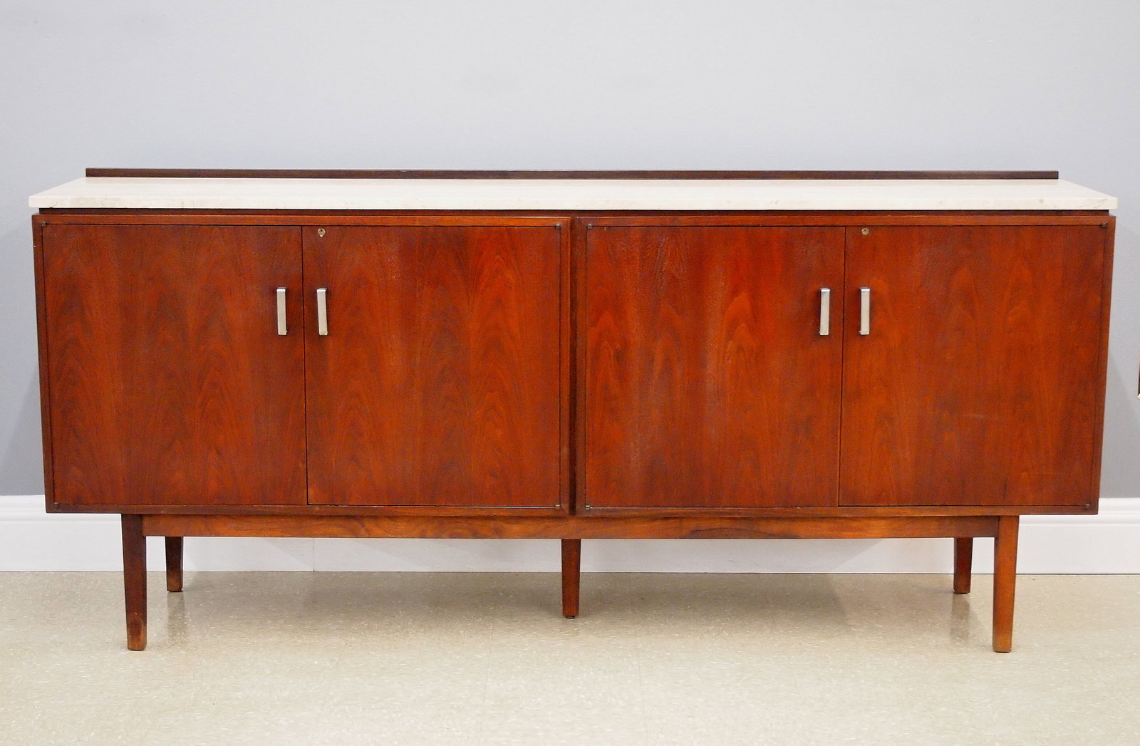 MCM Entertainment Cabinet: A Mid Century Modern entertainment cabinet. Teak construction with a Travertine top, features four hinged doors opening to reveal adjustable shelves and a pull out turntable shelf on a five legged