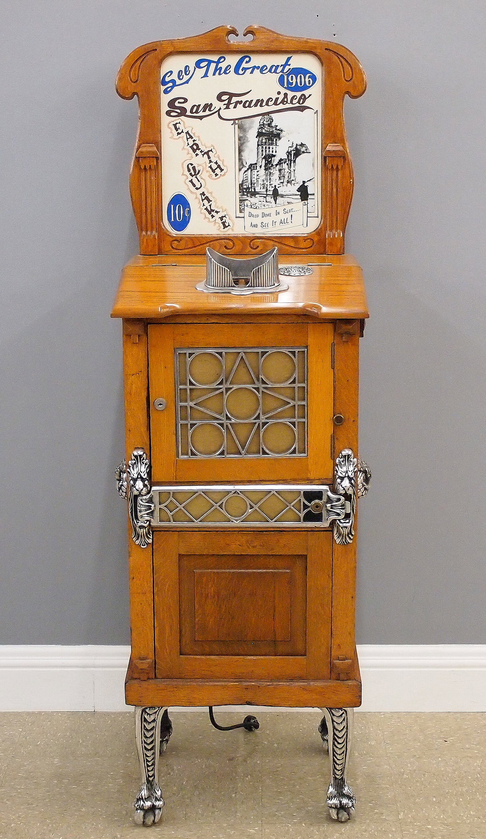 Mutoscope Arcade Machine: An early 20th century Mutoscope Autostereopticon drop card coin-op arcade machine. 10 cent viewer depicts the "San Francisco Earthquake" in a series of moving cards. In a molded Oak cabinet with marqu