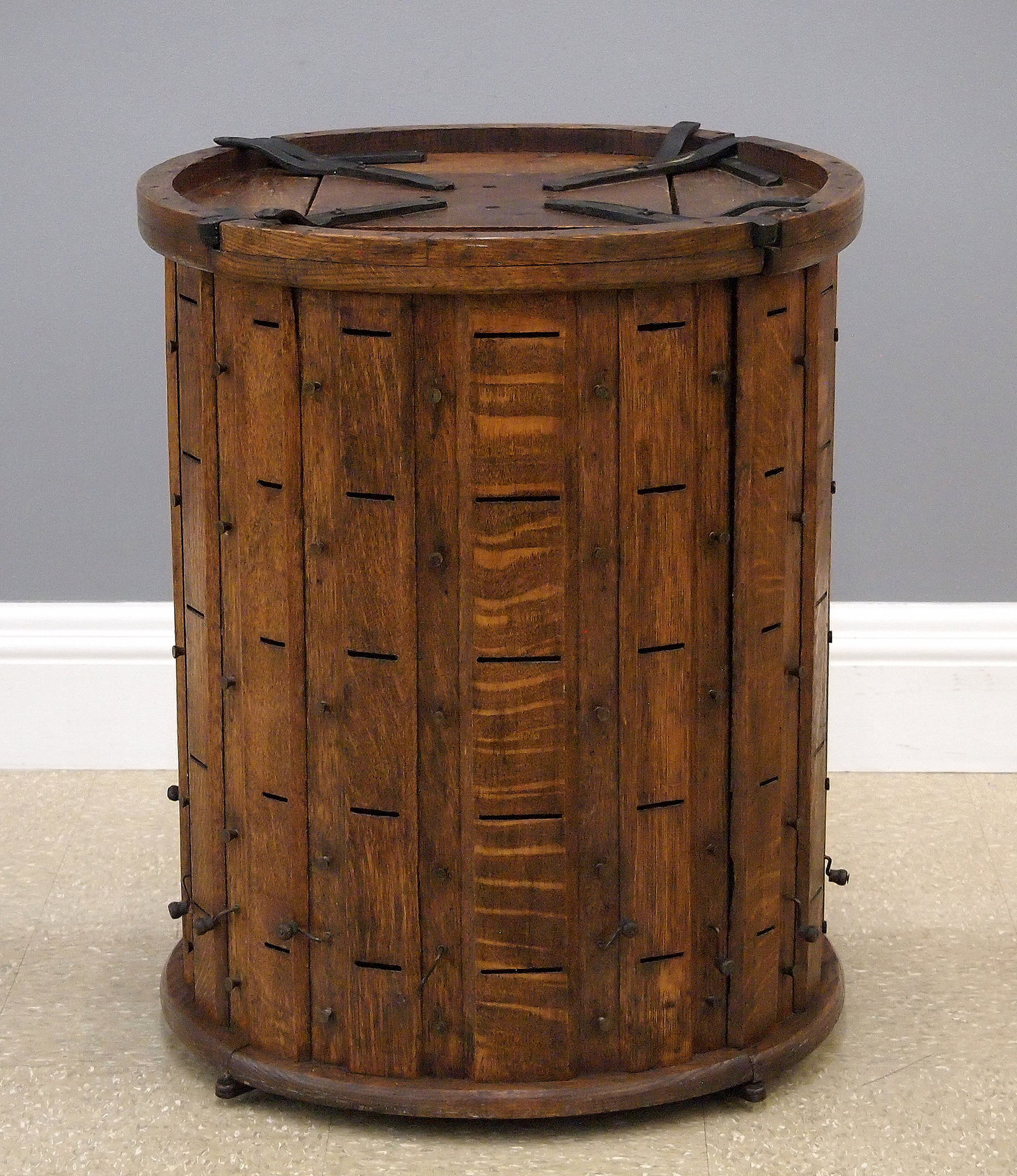 Lace/Ribbon Dispenser: A 19th American century lace and ribbon dispenser. Oak construction features revolving cylindrical form with four doors having 20 slots each to dispense lace or ribbon. Wear overall, with two cranks