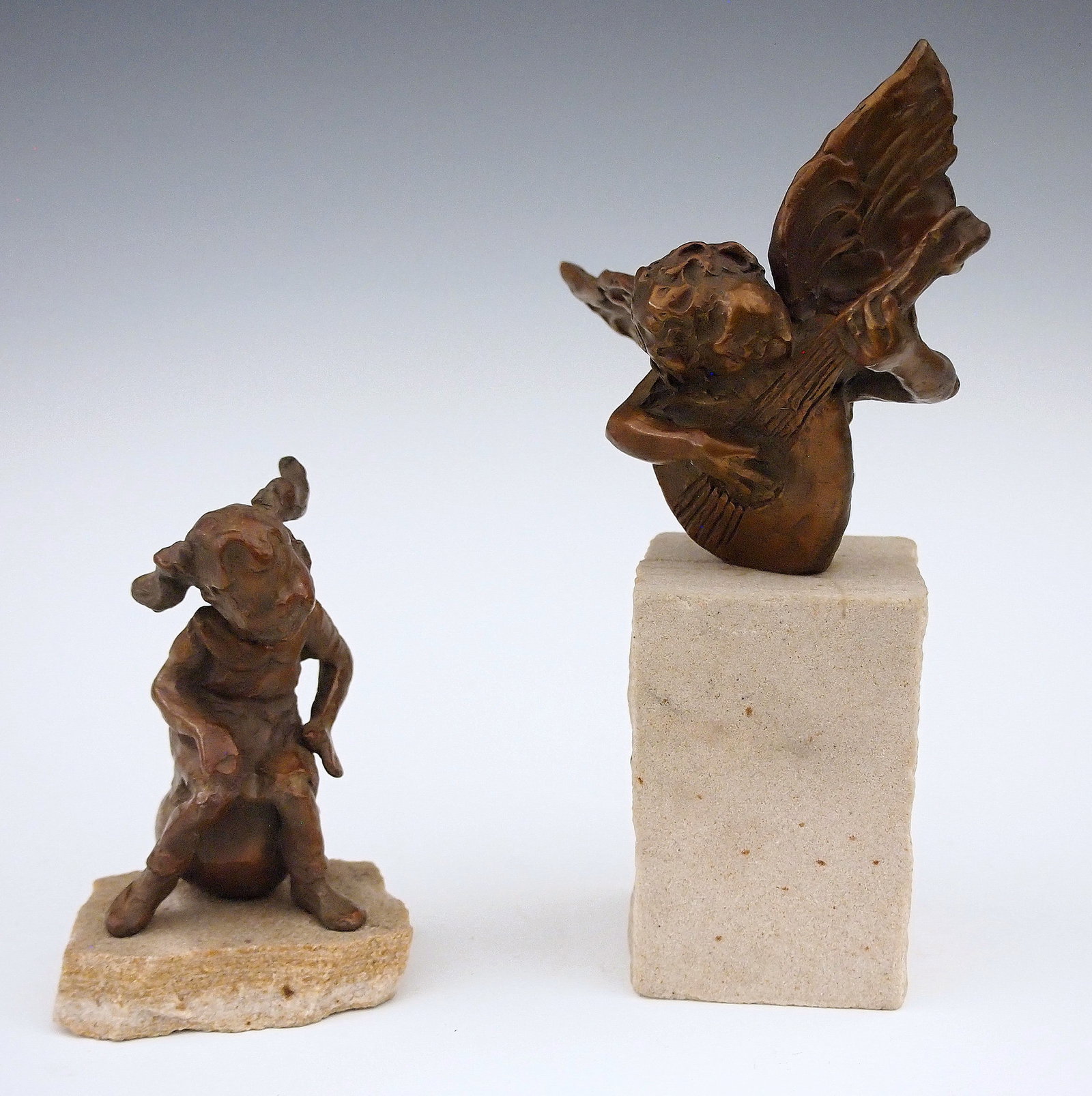 2 J. DeDecker Bronze Sculptures: Jane DeDecker, American, b. 1961. Two small Bronze figures including a little girl sitting on a ball and a Cherub playing a lute. Both signed "DeDecker", numbered "3/50" and "31/50" respectively. Very