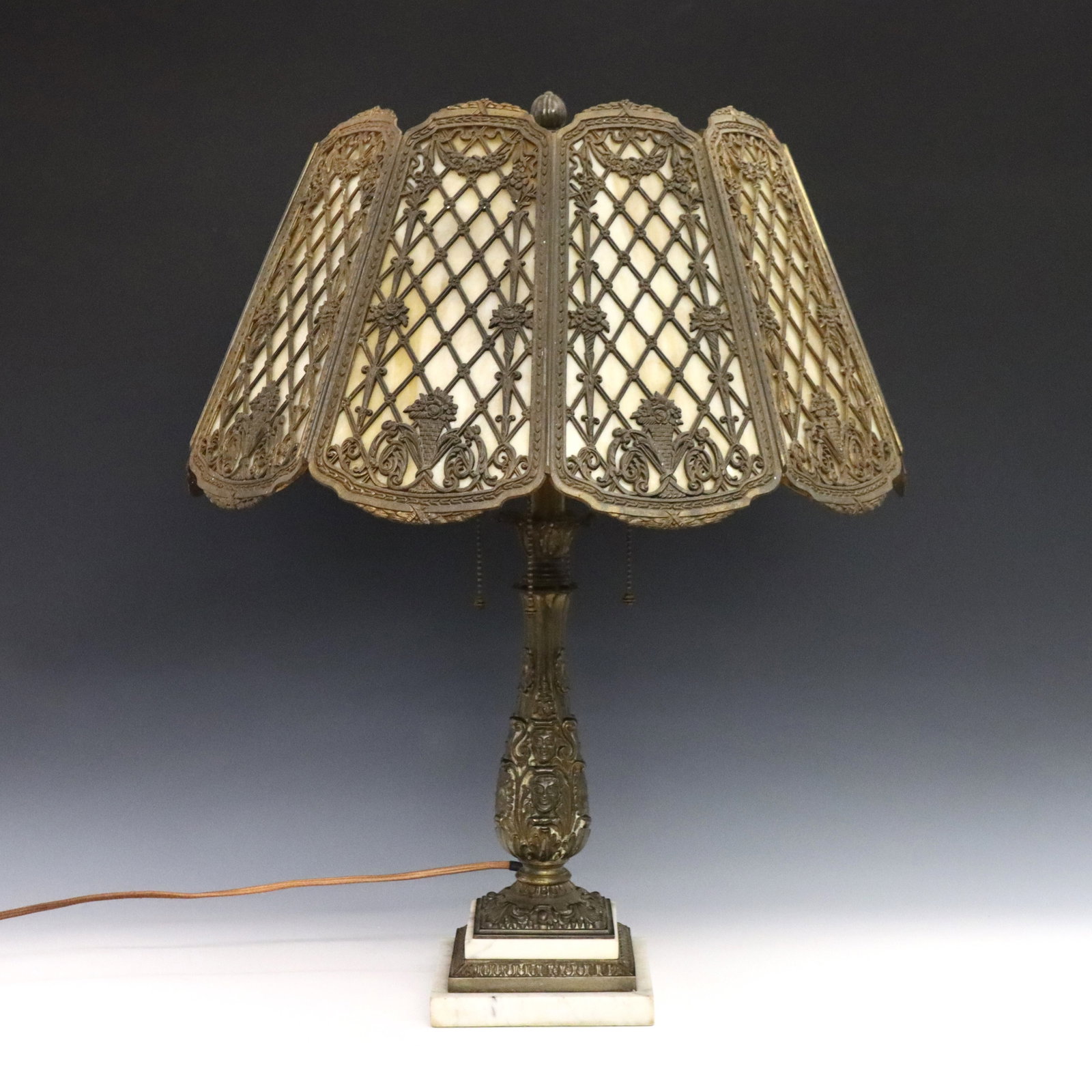Bradley & Hubbard Table Lamp: An early 20th century Bradley & Hubbard table lamp. Cast filigree shade with framed White/Caramel Slag glass panels on a cast base with four light design and stepped Marble foot. Base with cast