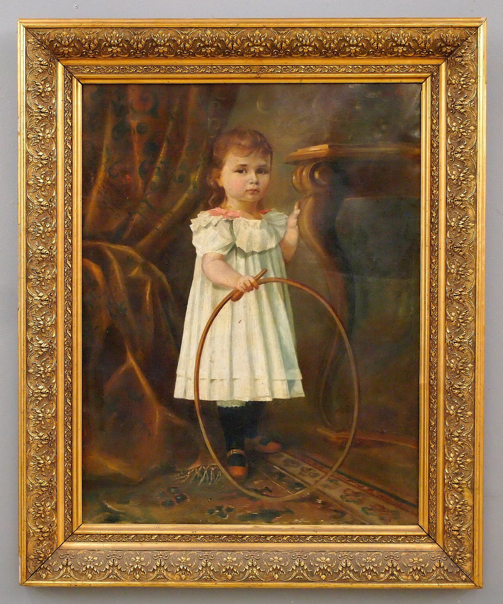 Portrait of a Girl: A turn of the century oil on canvas portrait of a girl. Depicts a little girl with a hoop and stick. Signed illegibly and dated "1904" upper right. Craquelure, some speckles of residue. Canvas 27 x