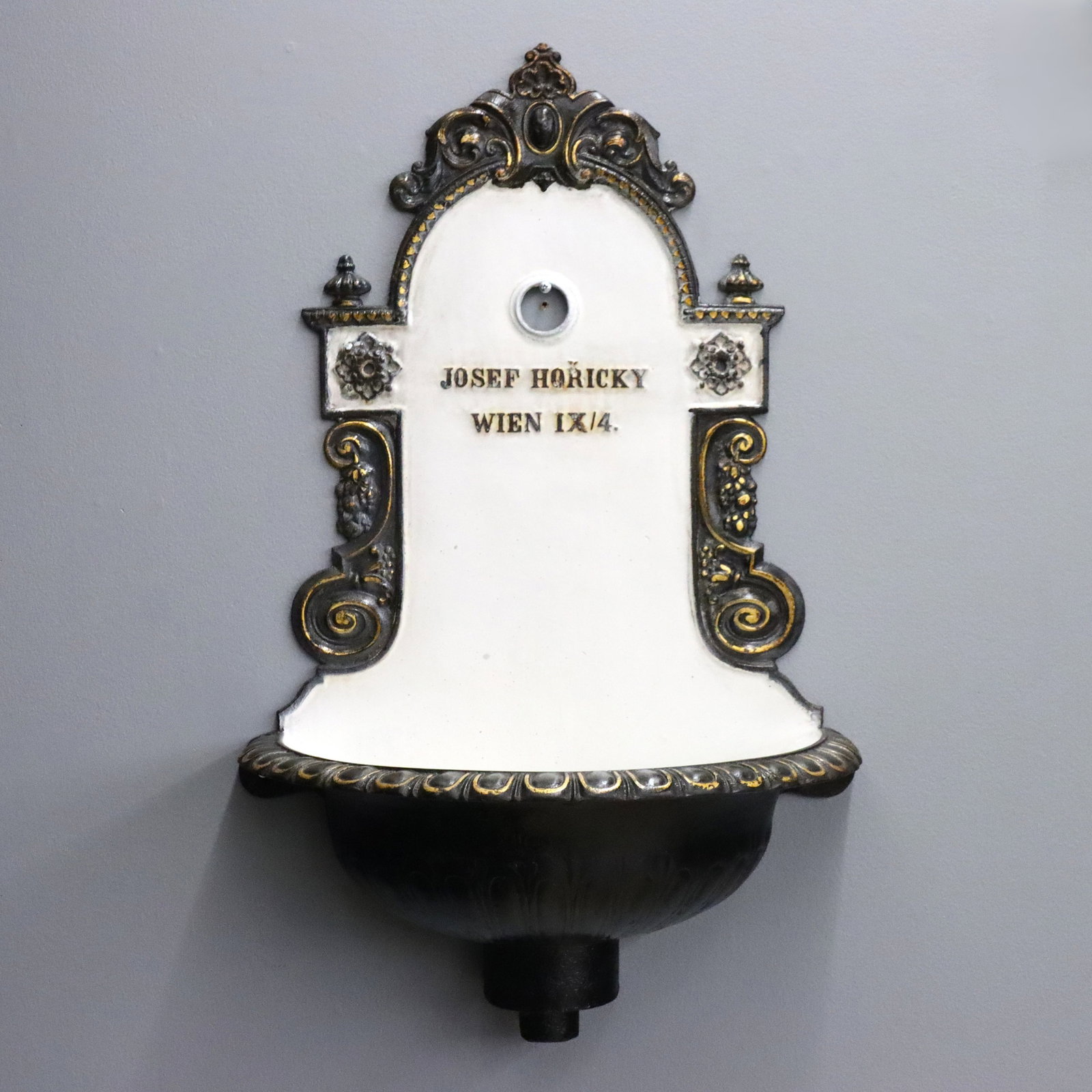 Victorian Iron Lavabo: A late 19th century Lavabo by "Josef Horicky, Wein, 1X/4". Cast Iron construction with shaped back and foliate scrolls above a half bowl with scalloped edge. Re-painted Black and White finish with Gol