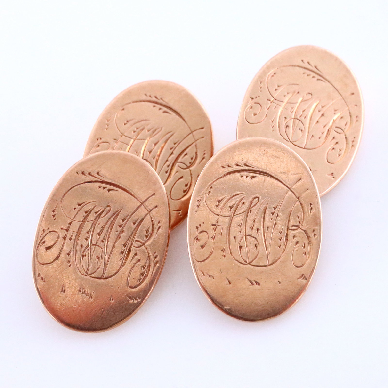 Pr English 9k Gold Cufflinks: A pair of vintage English 9k Rose Gold cufflinks attributed to Henry Griffith & Sons Ltd. Oval faces with engraved monograms and chain link connectors. Each marked "9 / 375", one with Chester hallmark