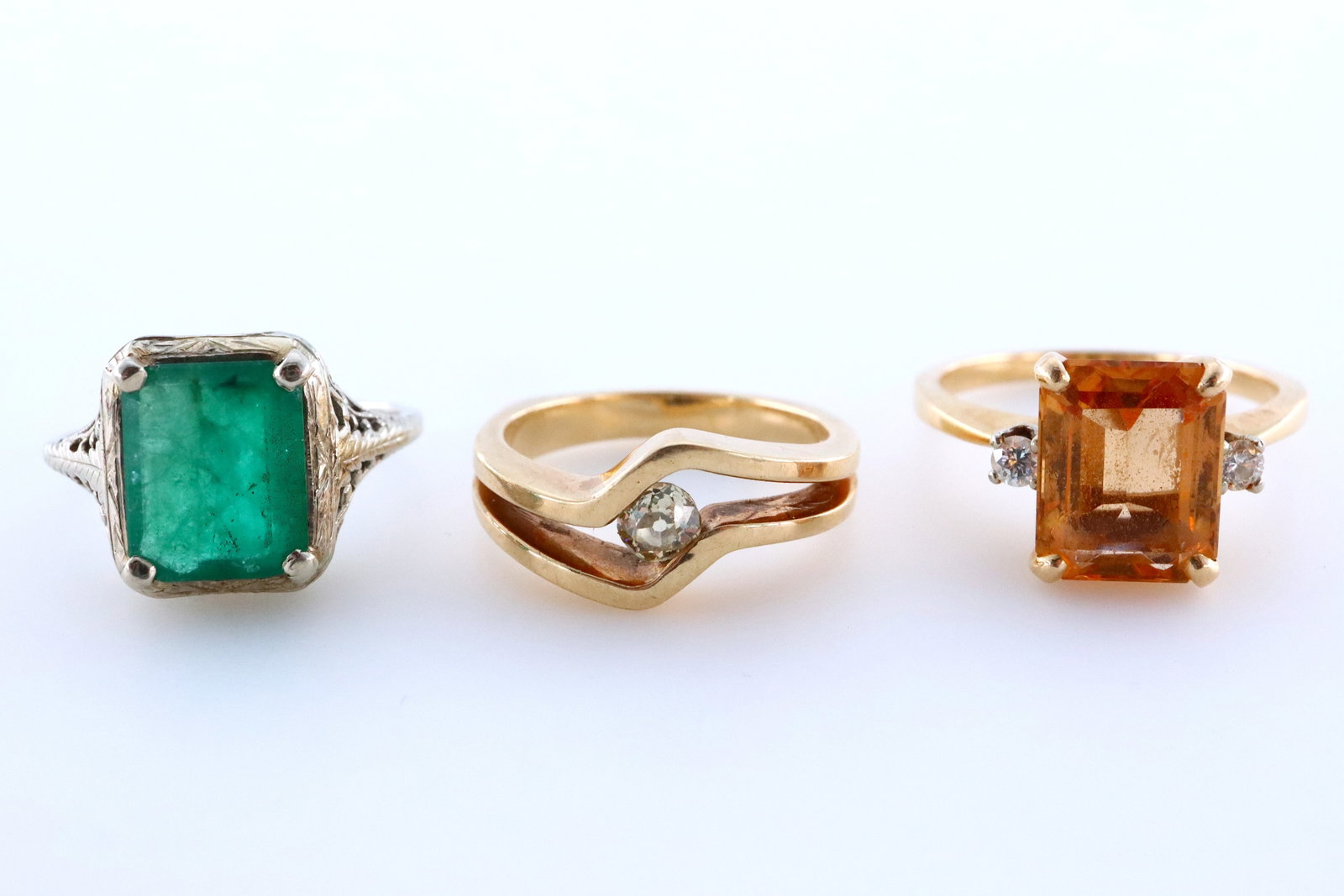 3 14k Gold Rings: Three 14k Gold rings. Includes a Yellow Gold ring featuring a rectangular cut prong set Citrine, approx. 8 mm x 10 mm, flanked by two White Sapphire accents (size 6 1/2), another Yellow Gold ring feat