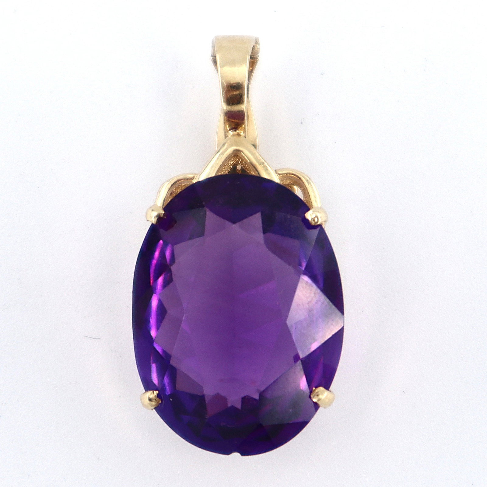 14k Gold & Amethyst Pendant: A 14k Gold and Amethyst necklace pendant. Features an oval cut prong set Amethyst, approx. 17.3 x 22.8 mm, on a high pierced mount with hinged hanger. Marked "14k" and "JMT" at clasp. 8.1 grams total.