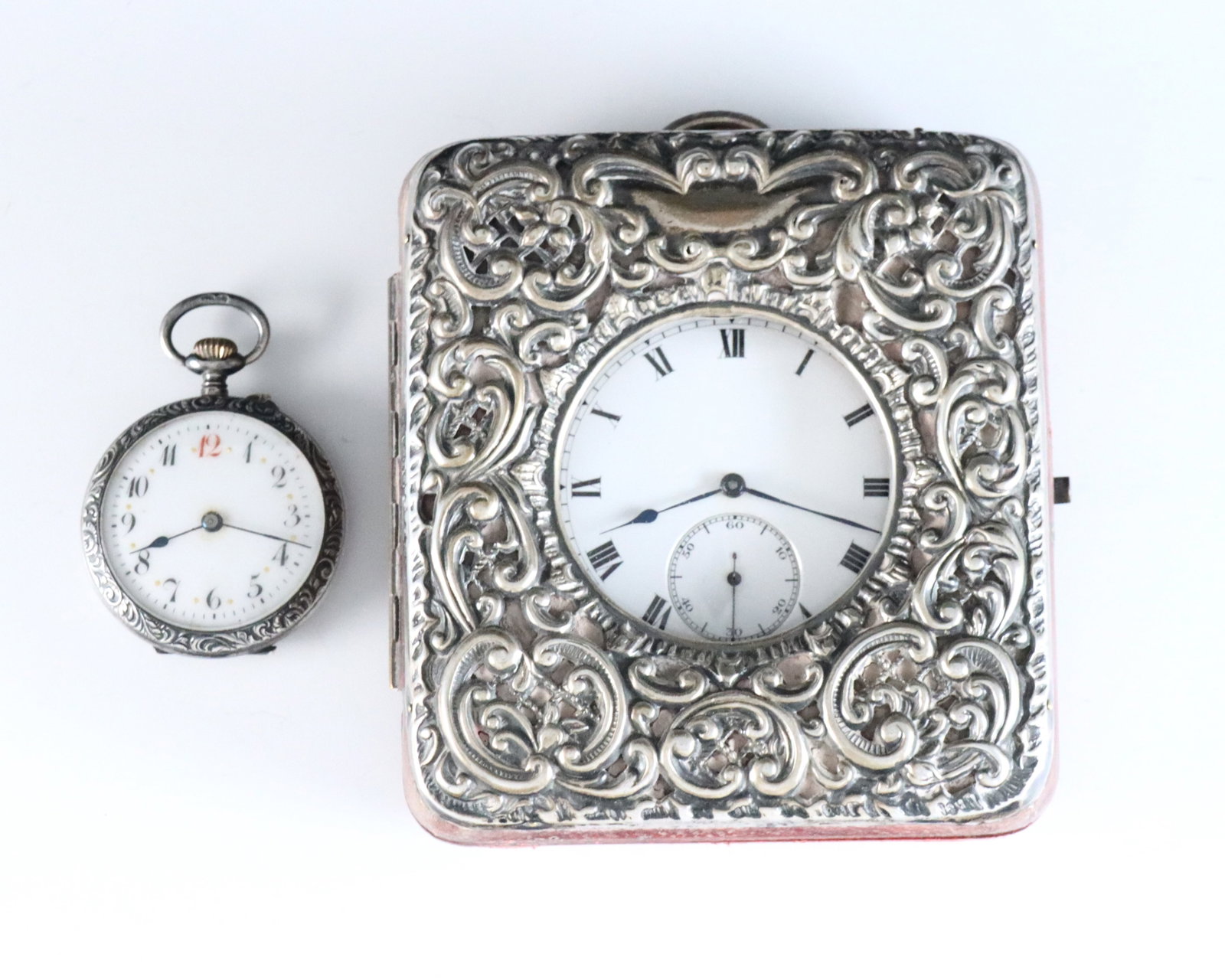 2 Sterling Pocket Watches & Stand: Two early 20th century Sterling Silver pocket watches. Includes a Ulysse Nardin pocket watch, 50mm with three-finger bridge movement serial #58650, porcelain dial and Roman numerals, in a Dennison Wat