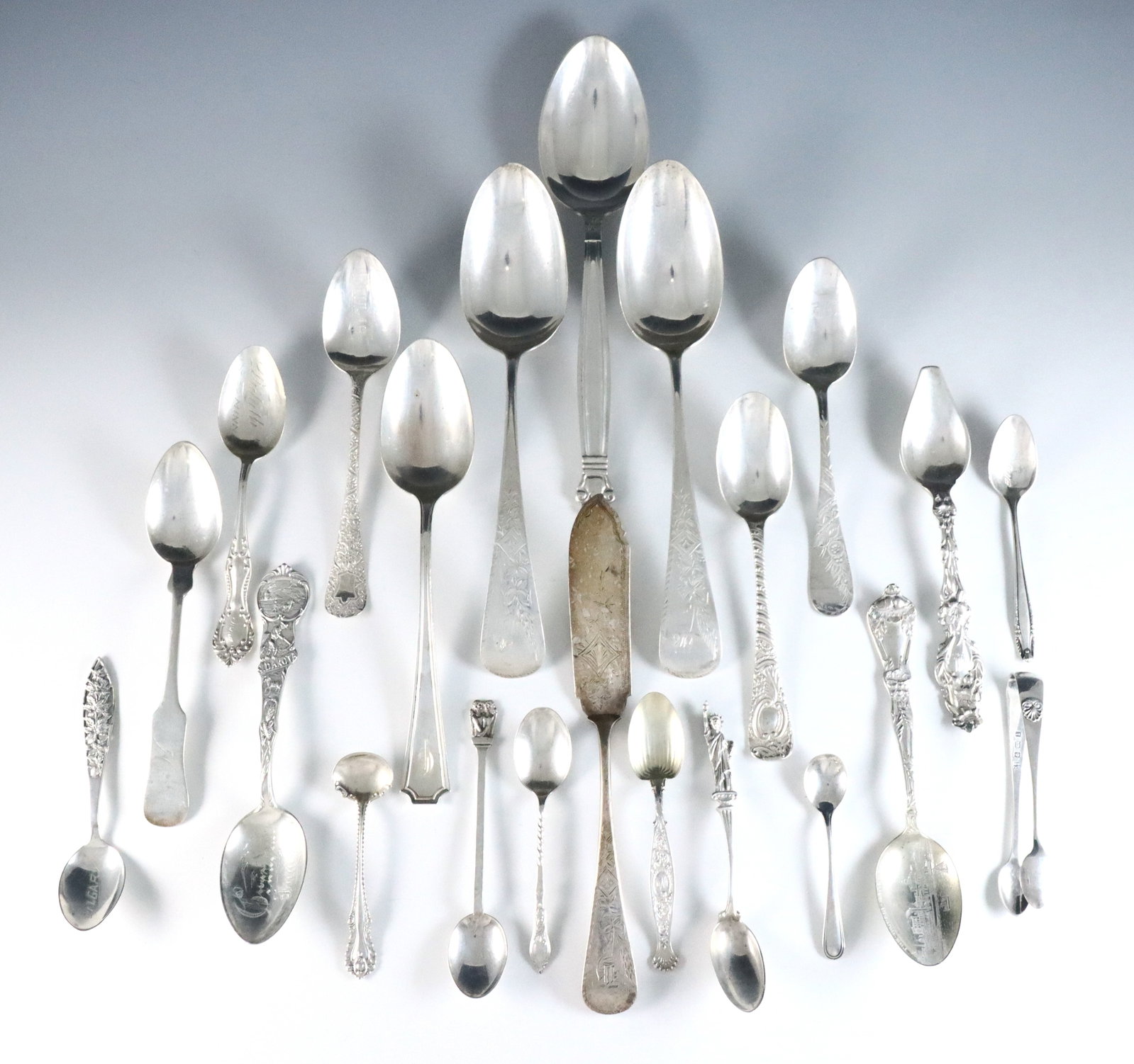 22 pc Sterling Silver Flatware: Twenty-two pieces of Sterling Silver flatware by various makers. Includes spoons, a butter knife and a pair of tongs. Each marked "Sterling" or "925". 16.44 troy ozs total. Some wear and damage, some 