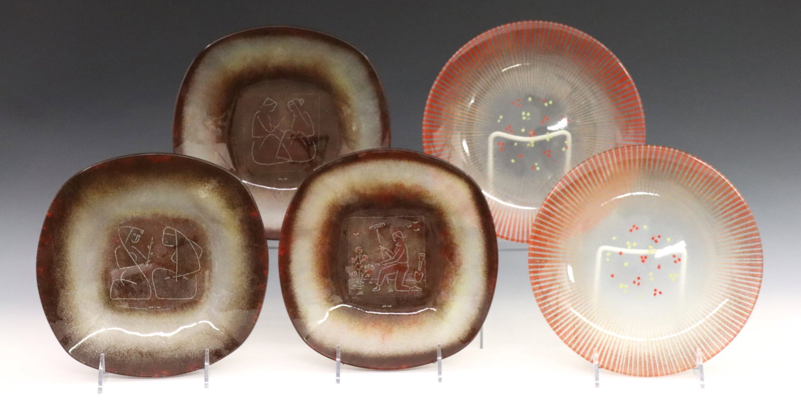 5 Maurice Heaton Plates: Five Mid Mod enameled glass plates by Maurice Heaton (Swiss/American, 1900-1990). Includes three with Brown enameled accents and etched designs at the wells entitled "Story Telling" and "In the Garden