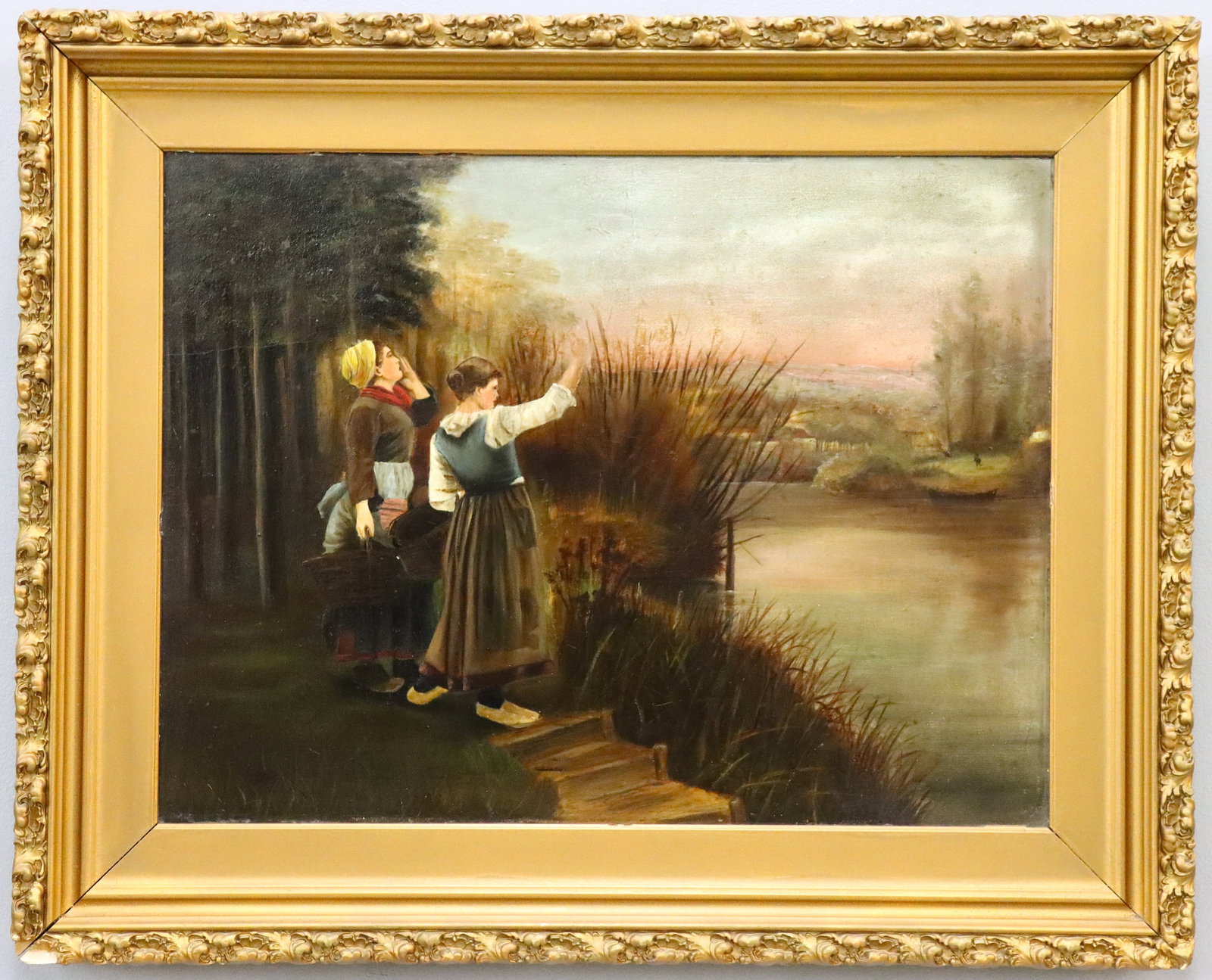 Riverbank Genre Scene: An early 20th century oil on board genre scene. Depicts two women on a riverbank signaling to a figure across the way. Unsigned. Craquelure, minor surface wear along edges. Board 24 3/8 x 18 3/8" high