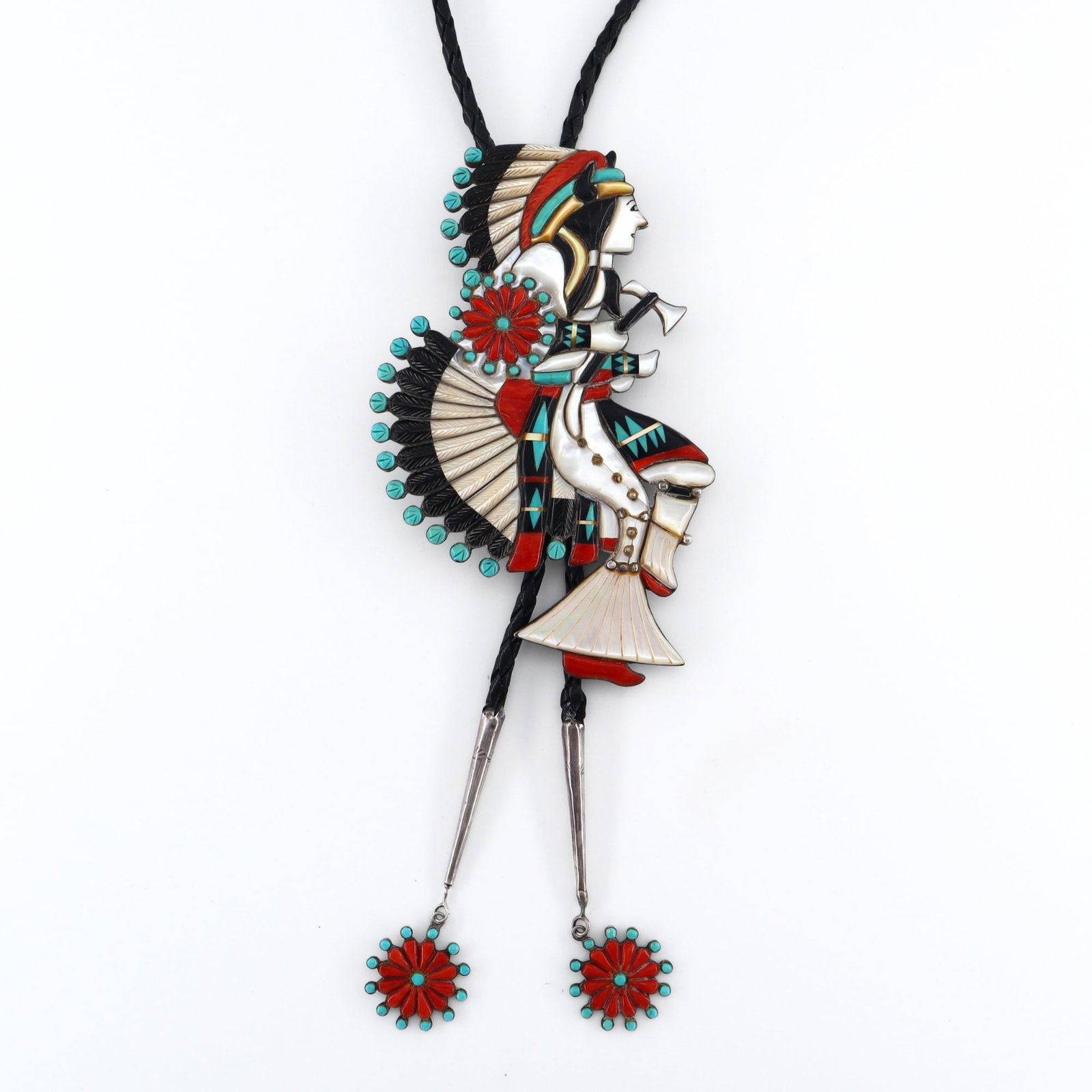 Zuni Sterling Bolo Tie: A vintage Zuni Sterling Silver bolo tie. Features a figural dancer design inlaid with Mother of Pearl, Turquoise, Coral, and Onyx, on a braided leather tie with Sterling aiguillettes and matching drop