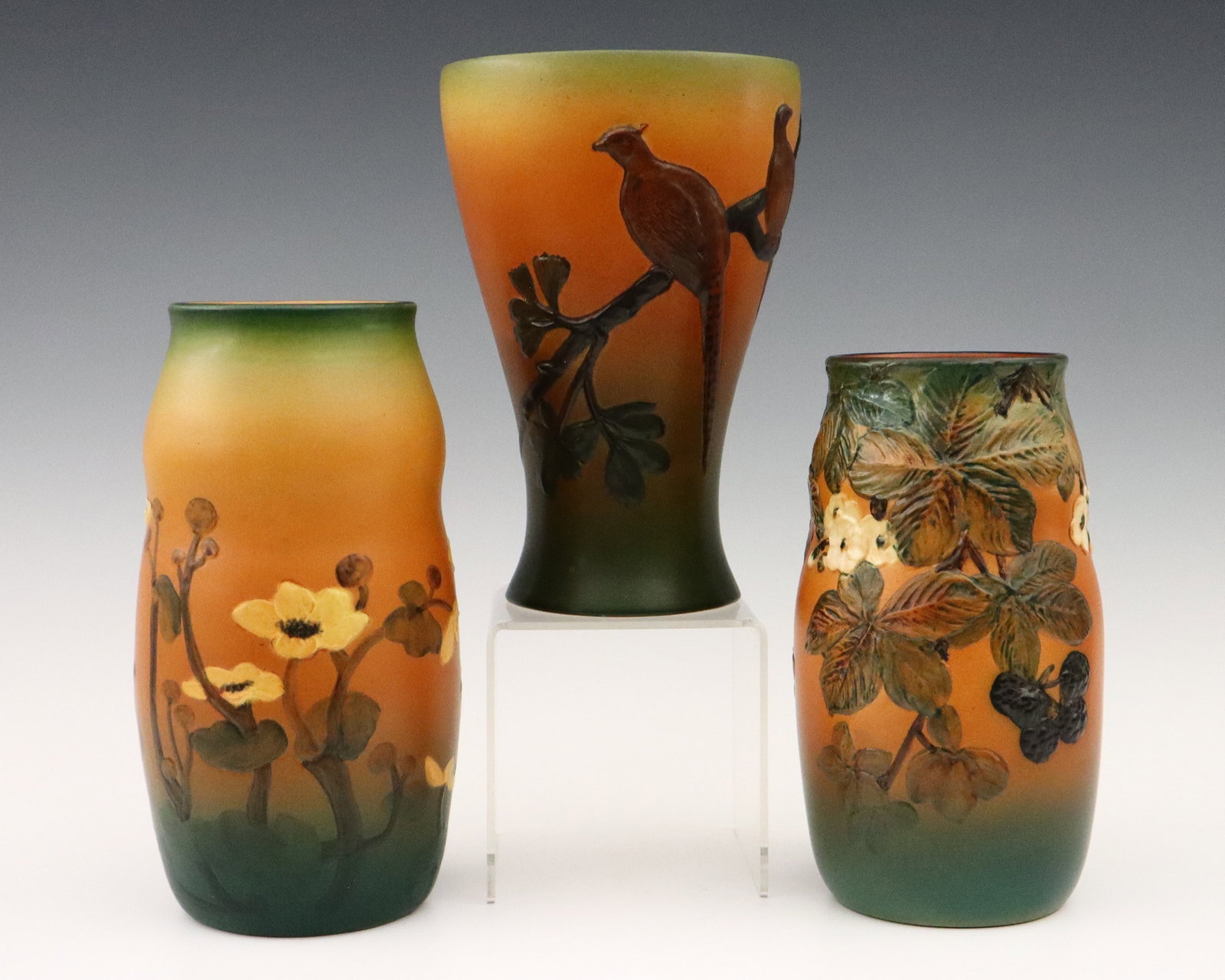 3 P. Ipsens Enke Art Pottery Vases: Three early 20th century P. Ipsens Enke Art Pottery vases. Molded bodies with multi-color decoration and designs featuring Phesants, florals and fruit. Impressed "PIE" with Crown marks and numerals. M