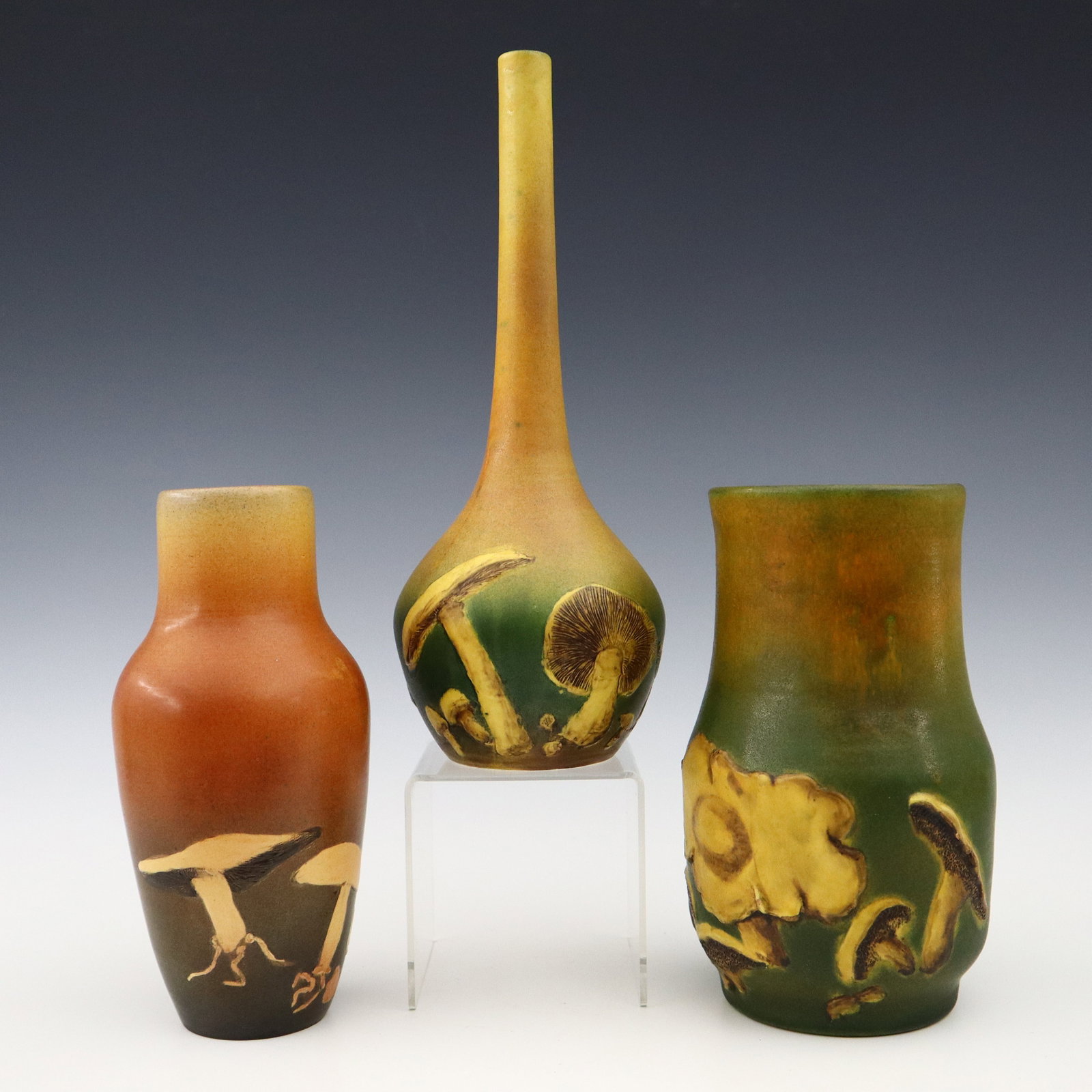 3 P. Ipsens Enke Art Pottery Vases: Three early 20th century P. Ipsens Enke Art Pottery vases. Molded bodies with multi-color decoration and Mushroom designs. Impressed "P. Ipsen / Kobenhavn" marks and numerals. Minor wear. Up to 12 1/2