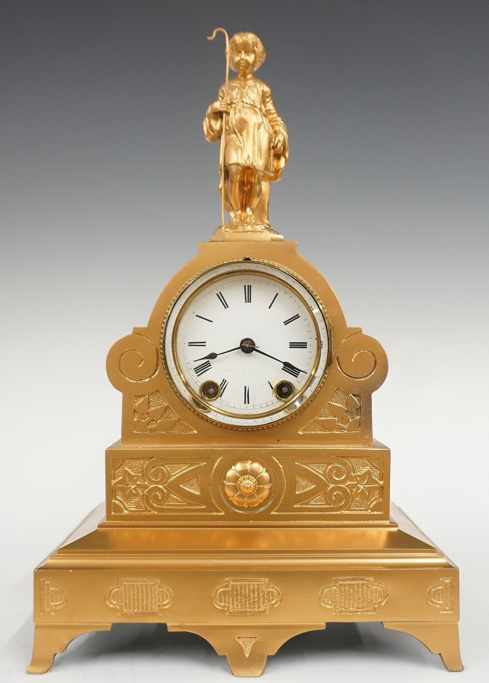 Seth Thomas Sons & Co. Mantel Clock: A late 19th century Seth Thomas Sons & Co. figural mantel clock. 8-day time and strike movement with porcelain dial and Roman numerals. Spelter case with Shepherd boy figure, shaped case and a plinth 