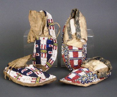 2 pairs of Moccasins: Two pair of Native American children's moccasins. Probably Sioux origin with beadwork designs. Both with wear and minor damage. Up to 7" long. ESTIMATE $200-400