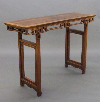 Chinese Rosewood Altar table: A 19th century Chinese Ming style Rosewood Altar table. Paneled top with shaped skirt and stretcher base and carved detail. Old finish with minor wear, pieced repair to top. 55 x 17 1/2 x 37" high. ES