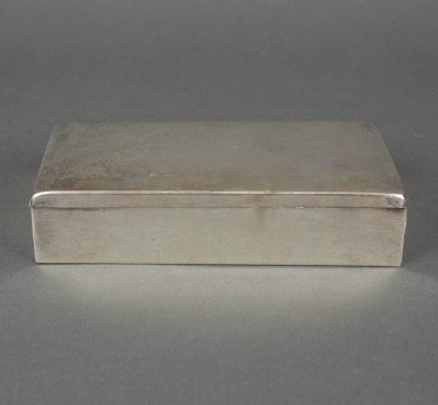 Sterling box: A 20th century Sterling Silver box with hinged cover and Mahogany lining. S & S manufacturer's mark. Some wear. 6 1/4" long. ESTIMATE $100-150