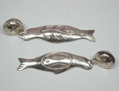 Pair of Denise Wallace earrings: A pair of Denise Wallace Sterling Silver Sea Lion form earrings. Slight wear. ESTIMATE $200-300