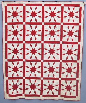 Patchwork Quilt: A turn of the century American Patchwork quilt. Unknown "Star" pattern in Red and White. Some wear, minor discoloration. 70 x 86" overall. ESTIMATE $200-400