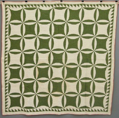 Patchwork Quilt: A turn of the century American Patchwork quilt. "Compass" pattern in Green and White. Some wear and minor staining. 72 x 72" overall. ESTIMATE $200-400