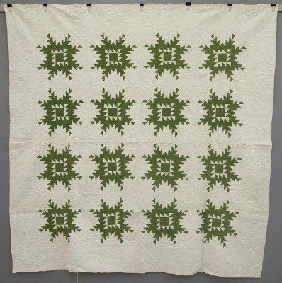 Patchwork Quilt: A turn of the century American Patchwork quilt. Pieced Star pattern in Green and White. Some wear and minor staining. 74 x 75" overall. ESTIMATE $200-400