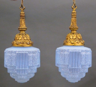 Pr of Art Deco Pendant lights: A pair of Art Deco pendent lights. Gold painted foliate fixtures with Blue Opalescent molded glass shades. Minor paint wear, some small splits in metalwork. Each approx. 25" high plus hanging chains. 