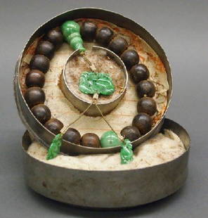 Chinese jade and wood prayer beads: Chinese carved jade and wood prayer beads. Carved wood beads with seed pearl and carved jade bead and avian form pendant accents. Within a fitted metal box, that is stamped at the underside. Minor wea