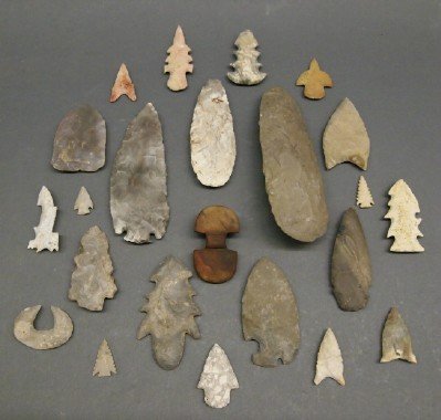 23 Native American Weapon Heads: A Group of Twenty-Three Native American Weapon heads. Including Eight arrow heads, Twelve spear heads, Two implements, and One adze. All of Carved flint or stone. Wear to each. ESTIMATE $200-300