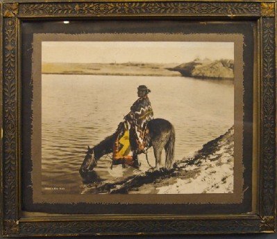 C.H. Carpenter Photograph: Charles H. Carpenter, American, 19th-20th Century. Photograph is titled "From a Dry State" and depicts a Native American mounted on a horse, which has stopped to drink. Sepia toned with applied color,