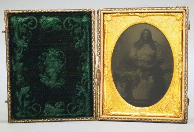 Ambrotype of a Native American: A 19th Century Ambrotype of a Native American. Portrait of a man, shown seated, in full length. No apparent markings and within a gutta percha case. Very minor wear/flaking to the plate (when removed