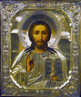 19th C. Russian Icon: A 19th Century Russian Icon of "Christ the Teacher". Tempera on wood panel with repousse .875 silver and vermeil Oklad. The image portrays Christ with an ornate halo about His head, His right hand lif
