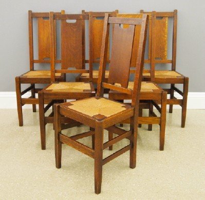 6 Gustav Stickley dining chairs: A set of six American Arts and Crafts Period Oak Dining Chairs, by Gustav Stickley, Model #308. Oak construction throughout with "H" form back panels, slip out rush seats and box stretcher bases. Red 