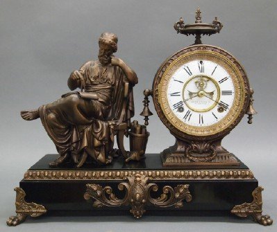 Ansonia "Philosopher" Clock: A Late 19th Century Ansonia "Philosopher" Figural Mantle Clock. Eight day time and strike movement with open escapement and enameled Porcelain Dial. Having a Patinated metal case and figure of a Philo