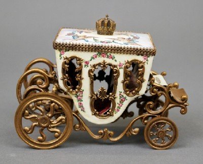 Austrian Miniature Coach: A Turn of the Century Austrian Miniature Coach. Enamel decorated with imagery of putti, garland, and Courting motifs overall, set within an Ormolu frame. Stamped “Austria”. Minor wear. 4 3/4” x 